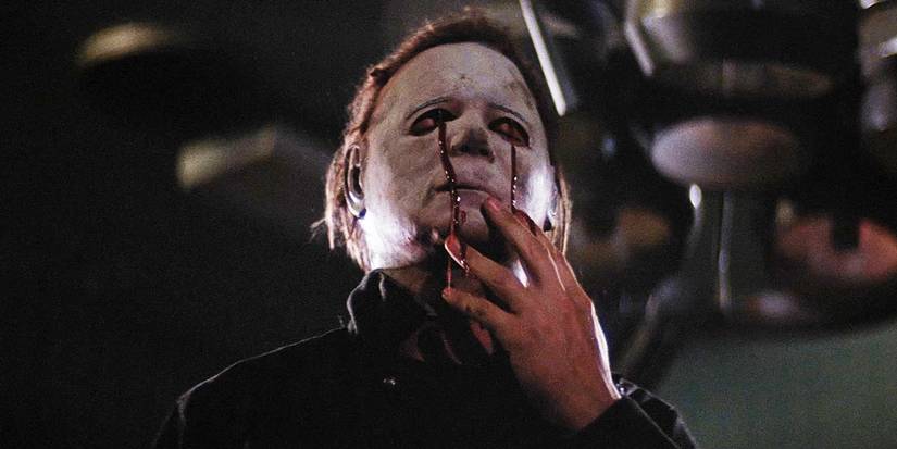 Michael Myers (Dick Warlock) holds his mask as his eyes are bleeding in Halloween II