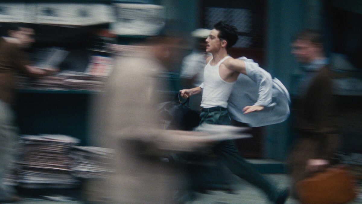 Timothée Chalamet running as the image blurs around him in Marty Supreme