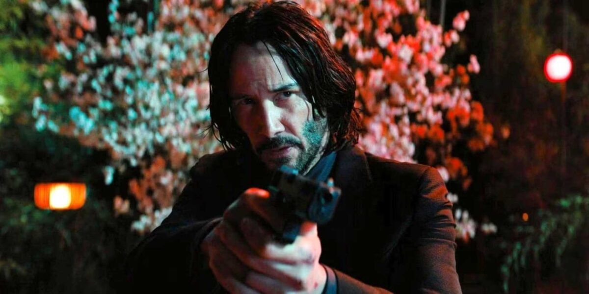 John Wick points his pistol offscreen in John Wick Chapter 4